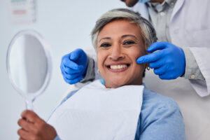 Happy senior woman, teeth and dentist for dental care, appointment or checkup at clinic. Portrait of elderly female person smile for tooth whitening, cleaning or oral, mouth and gum care at hospital.