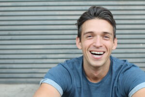 Smiling man with restored teeth after full mouth reconstruction