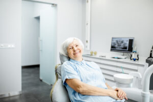 Denture being cleaned with a soft brush under running water
